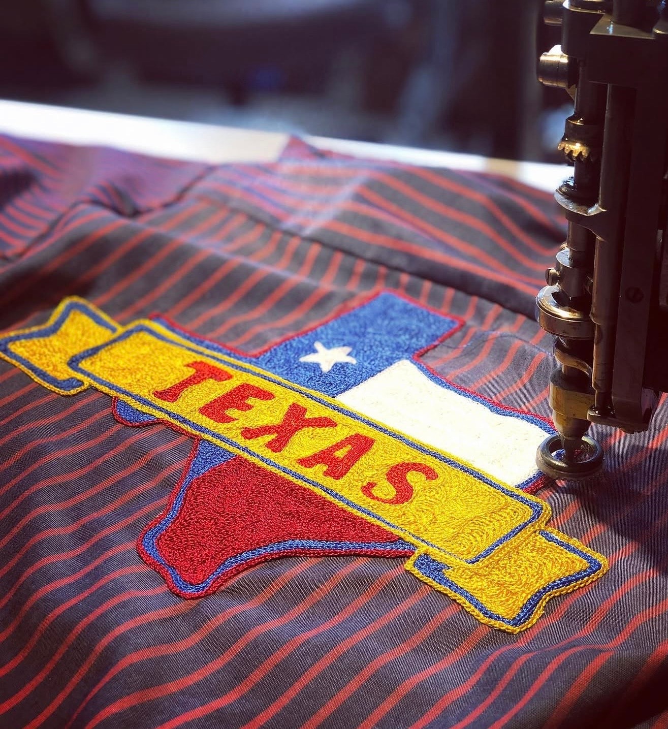 Embroidery machine stitching colorful Texas patch